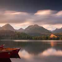 Canoes on the lake with hills