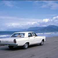 Car driving along the beach