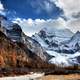 Clouds around the snowy mountaintops landscapes