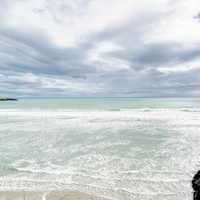 Clouds, ocean, and beach landscape