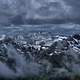 Clouds over the snowy mountain tops