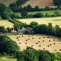 Farm landscape with fields and bales of hay