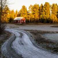 Farmhouse on snowy driveway landscape