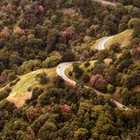 Forest and hills landscape with road