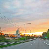 Highway and road into the sunset in town