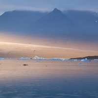 Iceberg, Sea, and Mountains