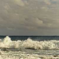 Large waves and surf coming in from the ocean