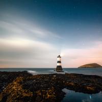 Lighthouse and landscape under the stars