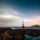 Lighthouse and landscape under the stars