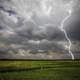 Lightning Strike on the farmland with stormy clouds