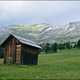 Lone Cabin on grassland by mountains