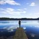 Man standing on the dock looking at the lake landscape