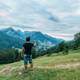 Man taking photo of mountain landscape with cellphone