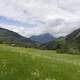 Mountains, clouds, and meadow landscape