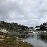 Mountains, clouds, lake, and valley