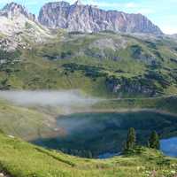 Mountains, fog, and pond landscape