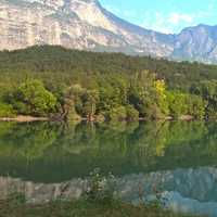 Nature landscape with trees, river, and mountains