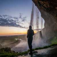Person standing besides the Waterfall