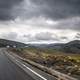 Road and landscape under clouds in the Andes