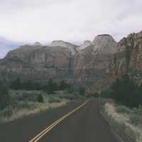 Road and rocky landscape of mountains with fog