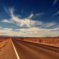 Roadway in the desert under the clouds