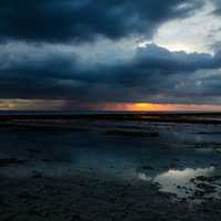 Seashore and water under stormy skies 