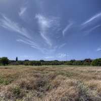 Sky and cloud streaks with landscape beneath