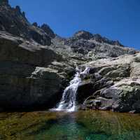 Small flowing waterfall coming down form rocks