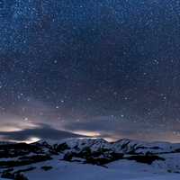 Snow Capped Mountains with a sky full of stars