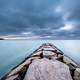 Storm clouds over the rocky walkway to the lake