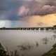 Storm clouds over the dusk lake landscape