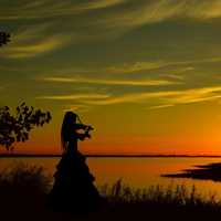 Violinist playing at sunset