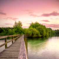 Walkway across the water into the pink skies