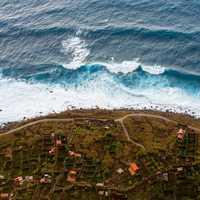 Waves from the sea crashing on the shoreline of a small town