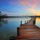 Wooden walkway into the lake sunset