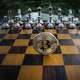 Bitcoin standing on a chess board
