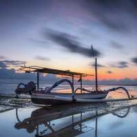 Boat under moving clouds on the water