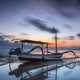 Boat under moving clouds on the water