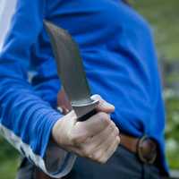 Camping Knife with person in blue shirt