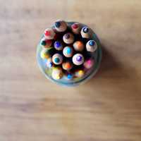 Colored pencils pointing up in glass