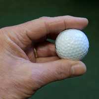 Hand holding golf ball