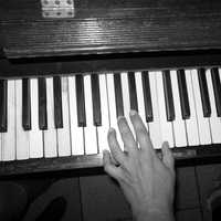 Hand playing keyboard keys