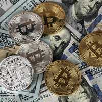 Hundred Dollar Bills and Bitcoin Coins