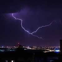 Lightning coming out of the clouds above the city