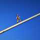 Man Figure walking towards sky on pole