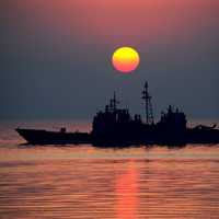 Ship sailing on the ocean at sunset