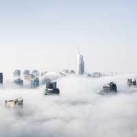 Skyscrapers through the clouds and mist