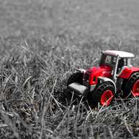 Small Red Toy Tractor in grass