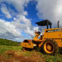 Tractors under skies and clouds