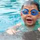 asian cute boy  splashing on summer pool